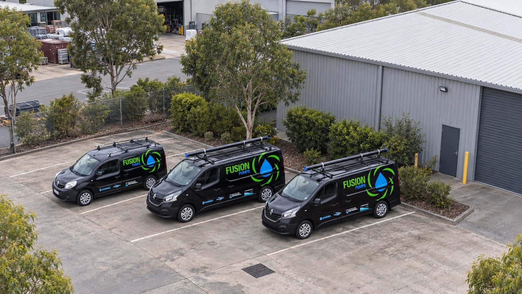 Three Fusion Pumps service vans at an industrial site